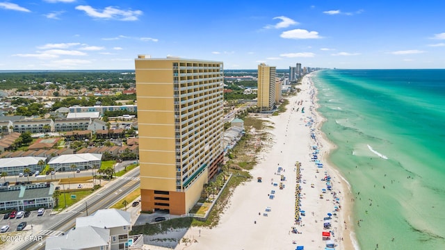 birds eye view of property featuring a beach view and a water view