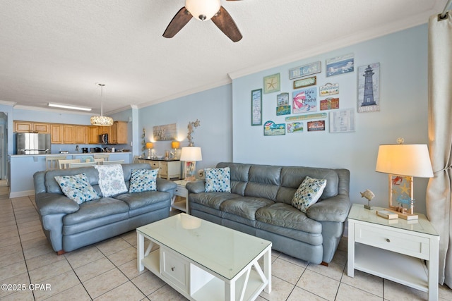 living area with a ceiling fan, a textured ceiling, light tile patterned flooring, and crown molding