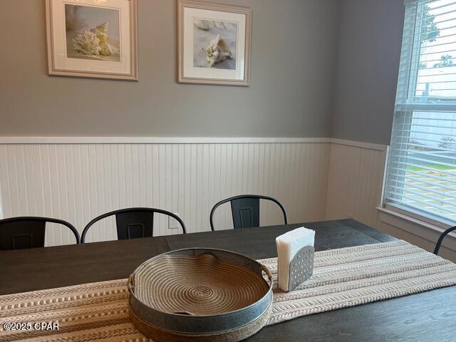 dining space featuring wainscoting