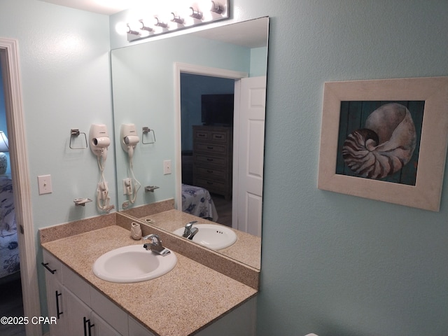 bathroom featuring vanity and ensuite bathroom