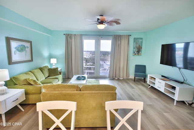 living area featuring a ceiling fan and light wood-style floors