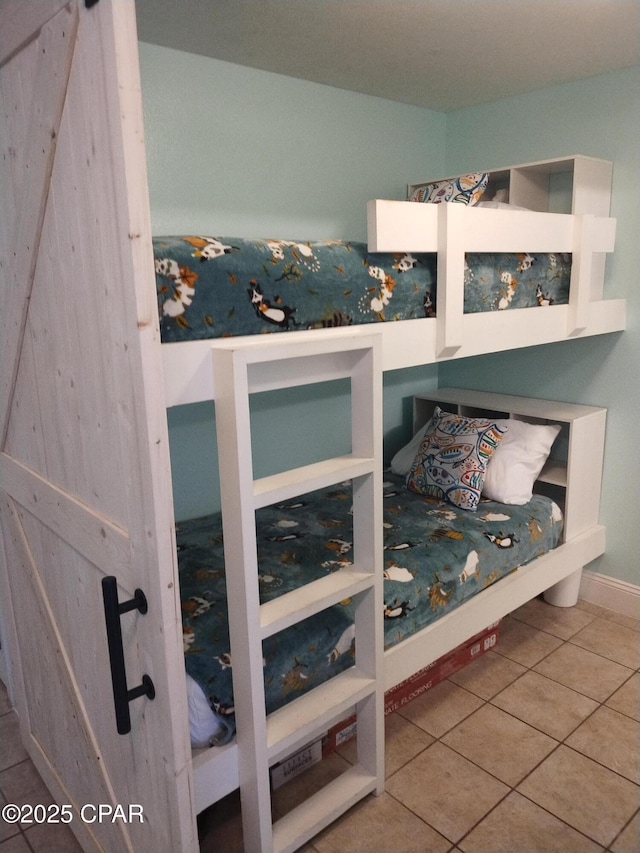 tiled bedroom with a barn door