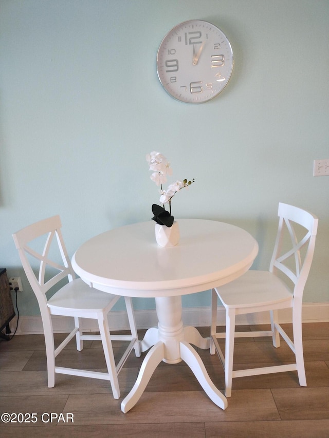 dining room with wood finished floors and baseboards