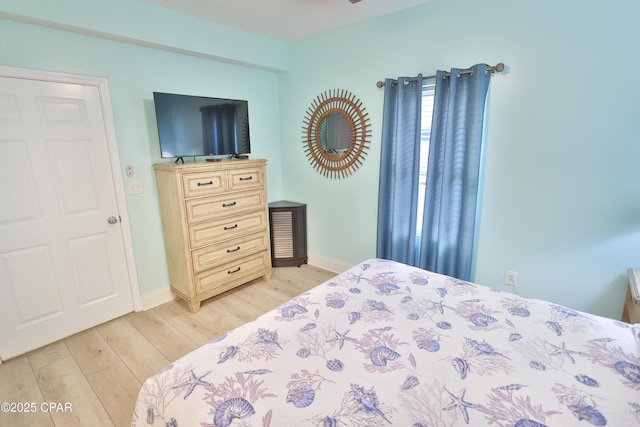 bedroom featuring light wood-style flooring and baseboards