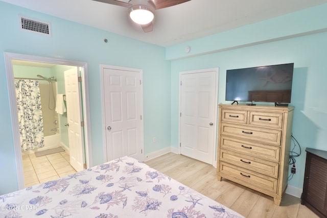 bedroom with visible vents, a ceiling fan, connected bathroom, light wood finished floors, and baseboards