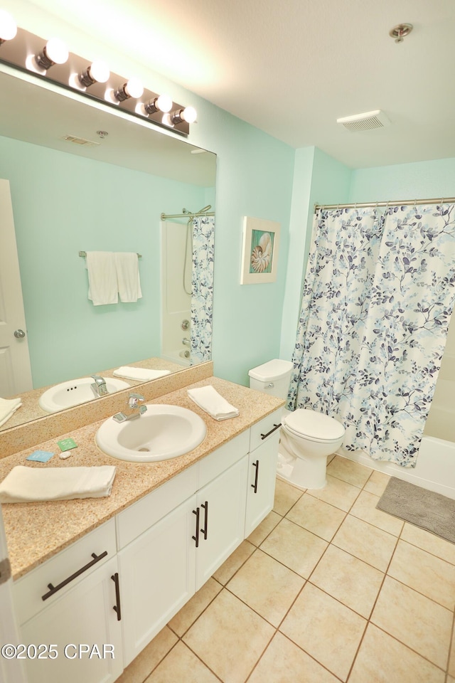 full bathroom with visible vents, shower / bath combo with shower curtain, toilet, tile patterned flooring, and vanity