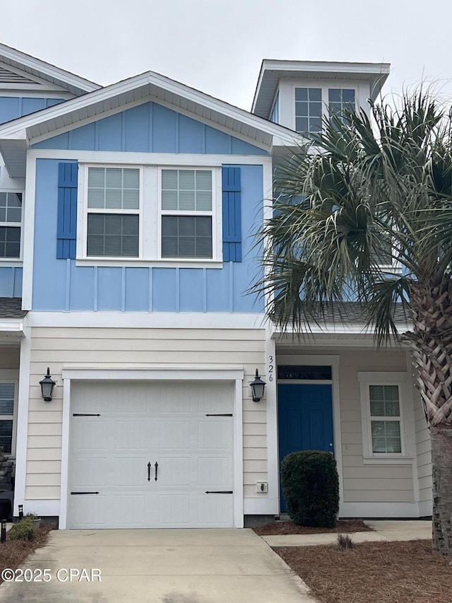 view of front of home featuring board and batten siding, driveway, and a garage