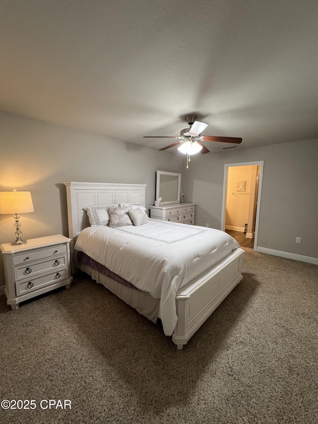 bedroom featuring baseboards, dark carpet, and a ceiling fan