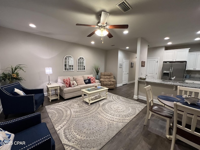 living area with recessed lighting, a ceiling fan, baseboards, visible vents, and dark wood-style floors