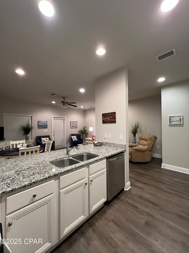 kitchen featuring open floor plan, a sink, visible vents, and dishwasher