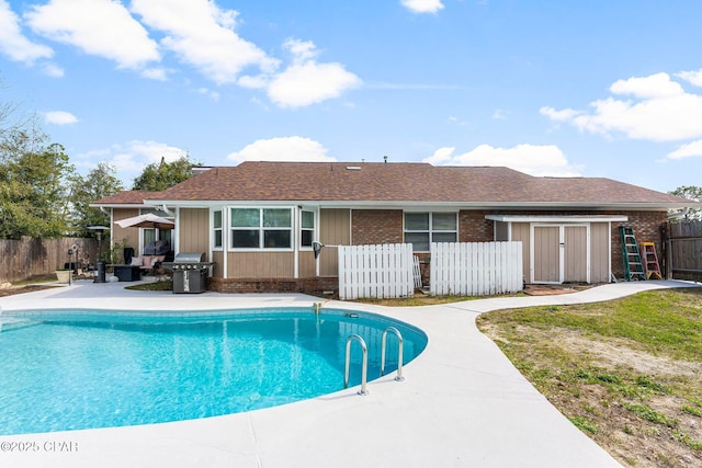 view of pool with a fenced in pool, a fenced backyard, a patio, and area for grilling