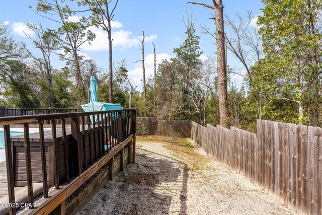 view of yard with a fenced backyard and a wooden deck