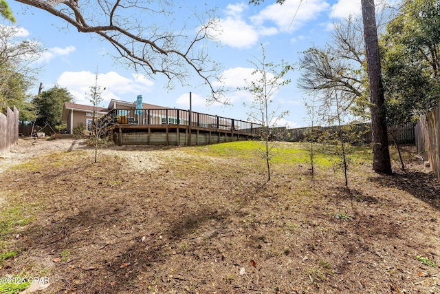 view of yard featuring a fenced backyard and a deck