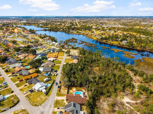 drone / aerial view featuring a residential view and a water view