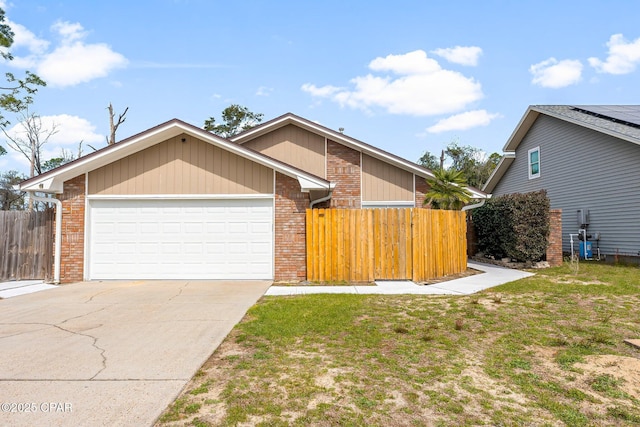 mid-century home with a garage, fence, a front lawn, and brick siding