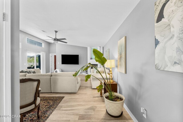 living room with baseboards, ceiling fan, visible vents, and wood finished floors