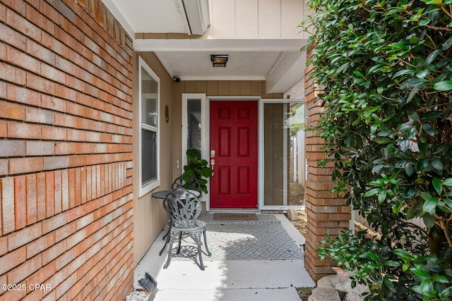 view of exterior entry with brick siding