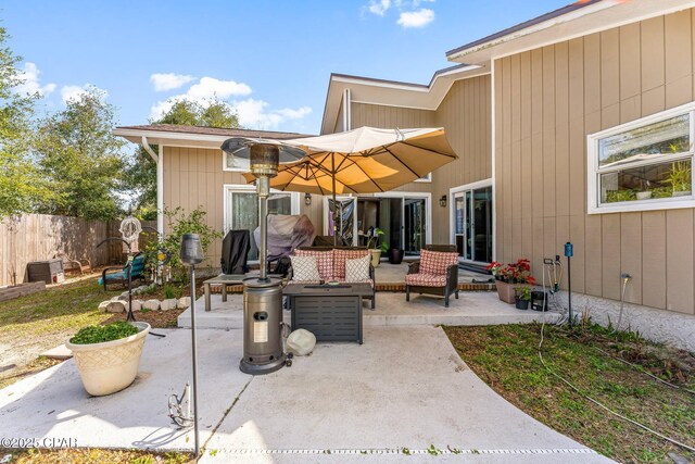 view of patio with outdoor lounge area and fence