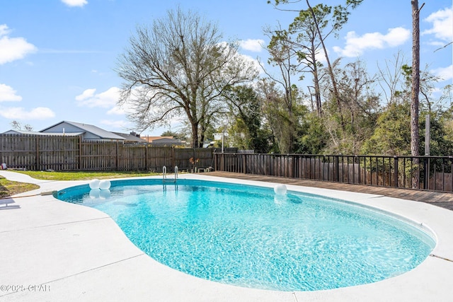 view of swimming pool featuring a fenced in pool, a fenced backyard, and a patio