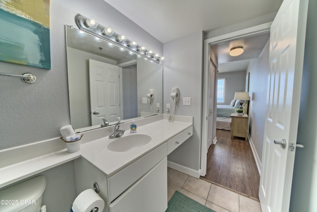 bathroom featuring vanity, baseboards, and tile patterned floors