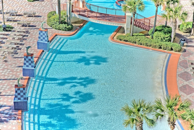 view of swimming pool with stairs