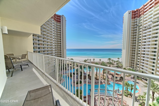 balcony featuring a water view and a view of the beach