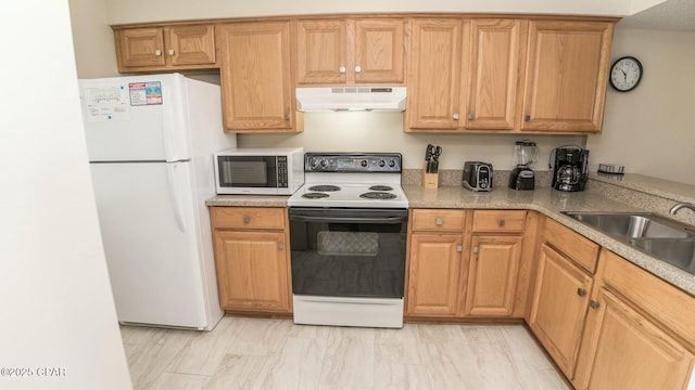 kitchen with under cabinet range hood, white appliances, a sink, and light countertops