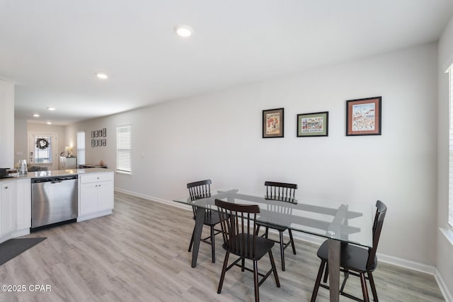 dining room with recessed lighting, baseboards, and light wood finished floors