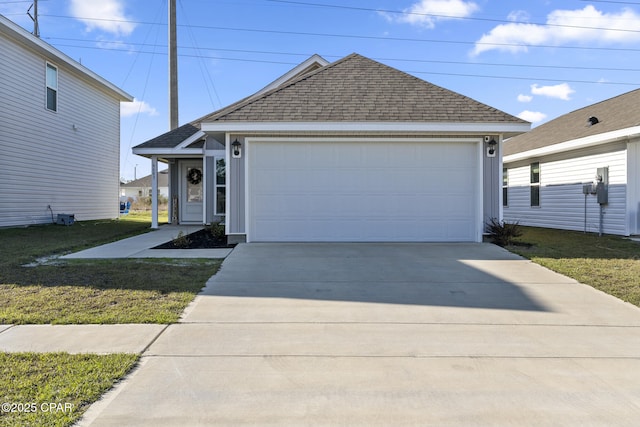 view of front facade with a garage, a shingled roof, and a front yard