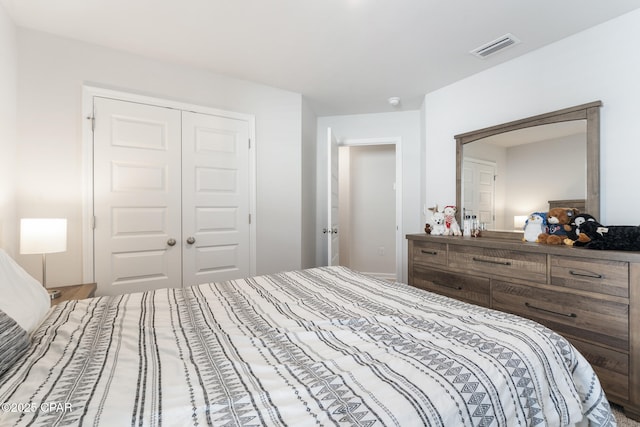 bedroom with a closet and visible vents