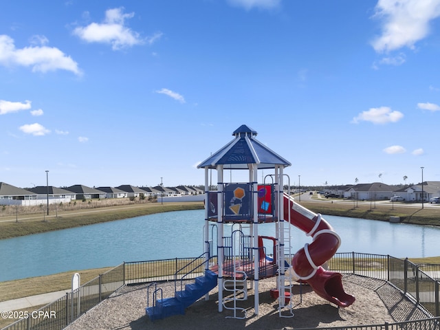 community play area with a water view, a residential view, and fence