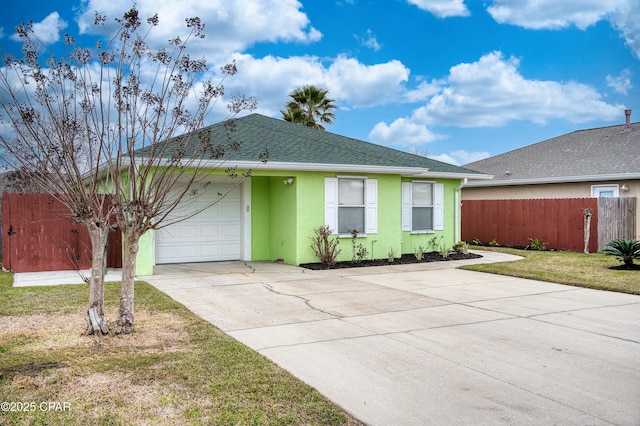 ranch-style house featuring driveway, an attached garage, fence, and stucco siding