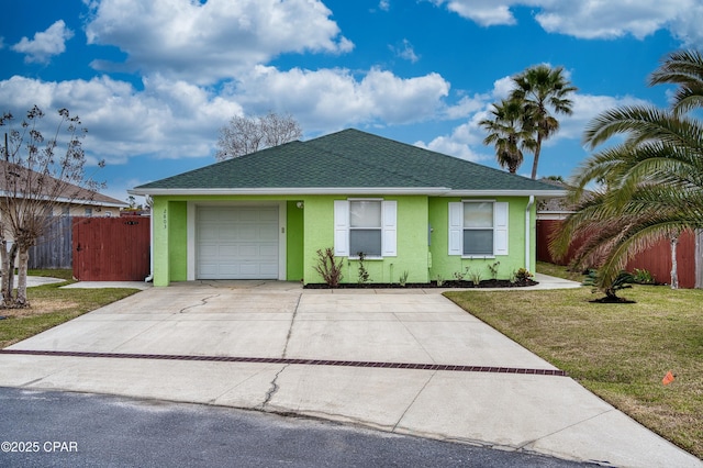 ranch-style home with driveway, a front lawn, roof with shingles, and stucco siding