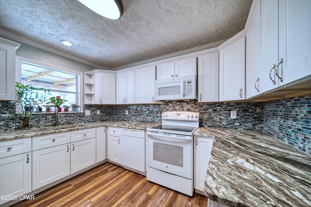 kitchen with white appliances, white cabinetry, open shelves, and wood finished floors