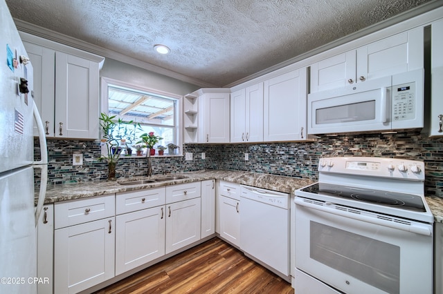 kitchen featuring white appliances, dark wood-style flooring, a sink, white cabinetry, and light stone countertops