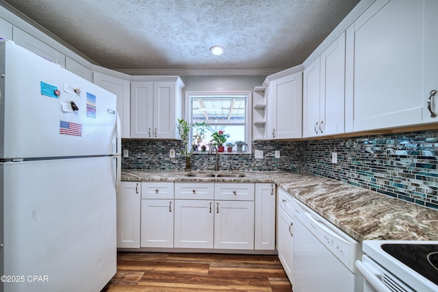 kitchen with stone countertops, white appliances, dark wood-type flooring, a sink, and white cabinets