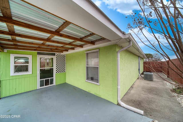 view of patio with central AC and fence