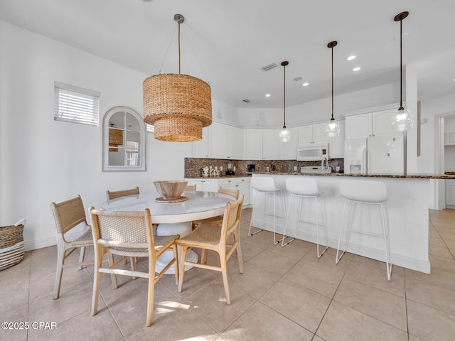 dining space with recessed lighting, visible vents, baseboards, and light tile patterned floors