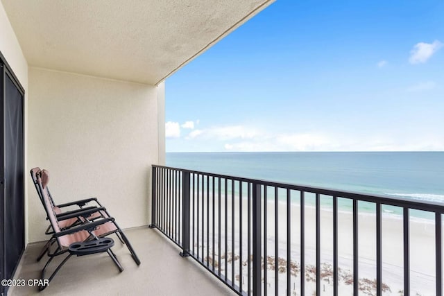 balcony with a view of the beach and a water view