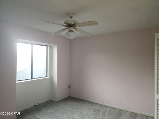 unfurnished room featuring baseboards, a ceiling fan, and light colored carpet