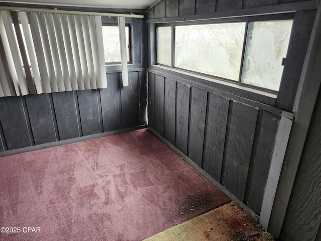 unfurnished sunroom featuring vaulted ceiling