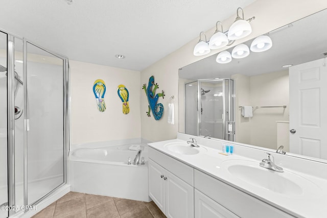 bathroom with a stall shower, a sink, a bath, and tile patterned floors