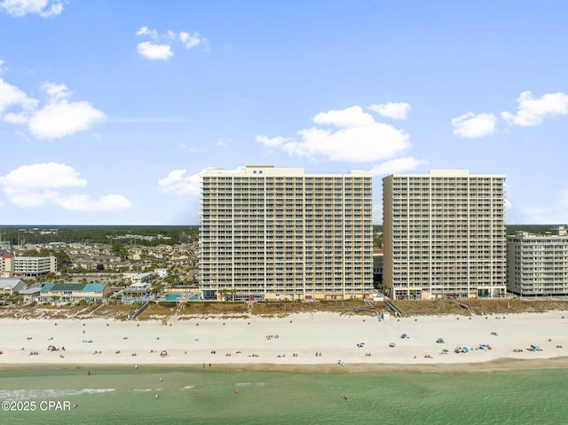 bird's eye view featuring a water view, a view of city, and a beach view