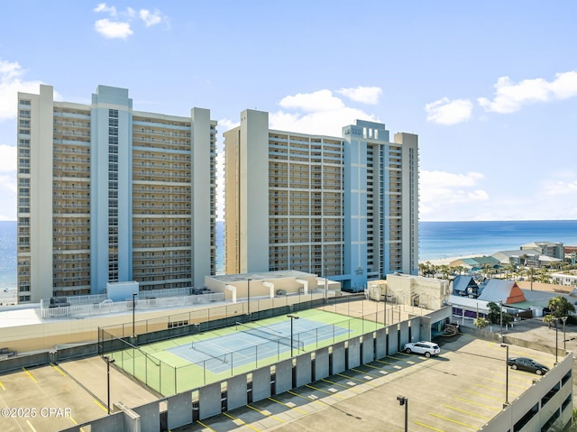 view of property with a view of city, a water view, and fence