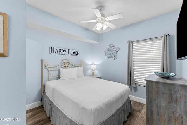 bedroom with ceiling fan, dark wood finished floors, and baseboards