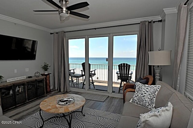 living area with a water view, plenty of natural light, and ornamental molding