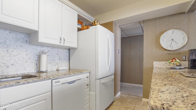 kitchen featuring light stone countertops, baseboards, white appliances, white cabinets, and a paneled ceiling