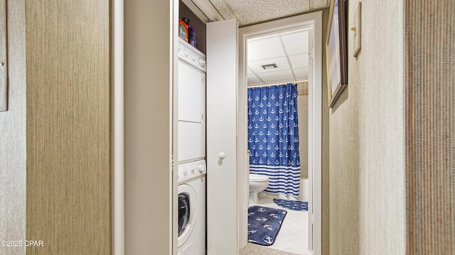 washroom featuring stacked washer and dryer