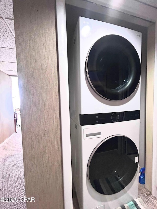 laundry area featuring stacked washer / dryer and laundry area