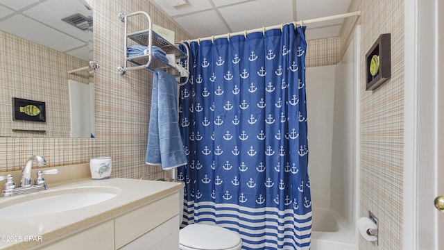 bathroom featuring visible vents, a drop ceiling, toilet, curtained shower, and vanity